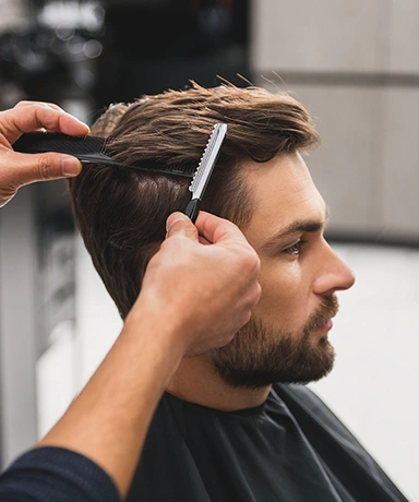 Male client getting haircut by hairdresser