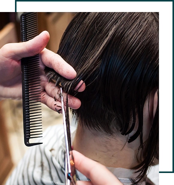 Master hairdresser cuts a man in the salon