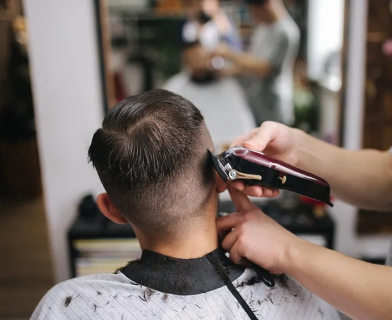 Back view of Men in beauty salon. Men's haircut in a barbershop.