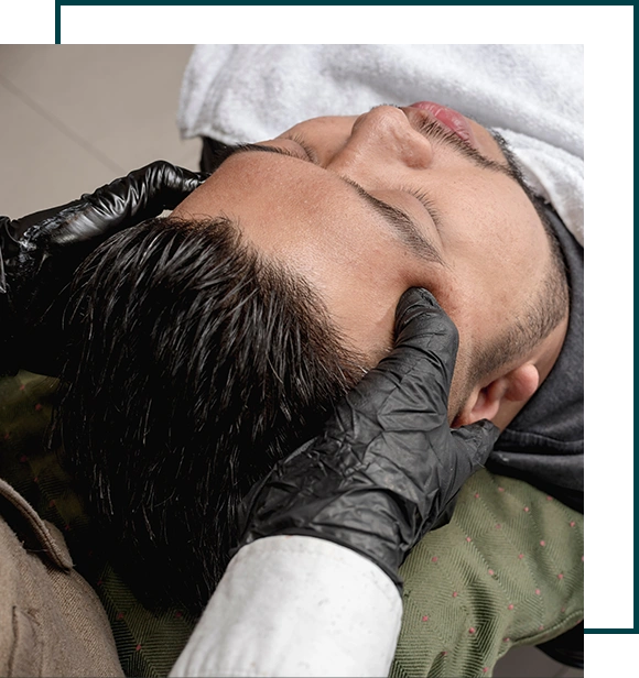 An asian man has a complimentary relaxing head massage